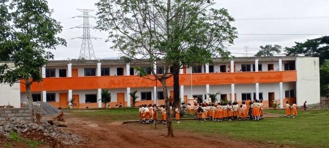 Pupils in front of a classroom block
